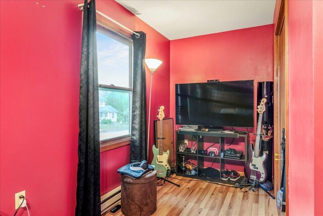 225 Northpark Dr W, East Stroudsburg, PA 18302 - living area featuring wood finished floors and a baseboard heating unit