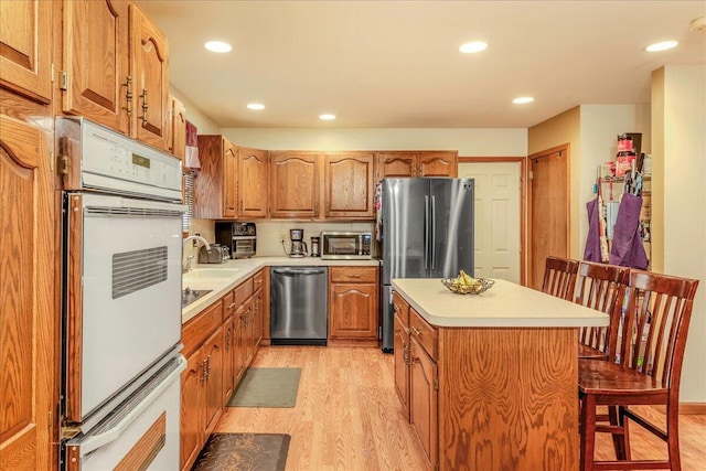 225 Northpark Dr W, East Stroudsburg, PA 18302 - kitchen featuring appliances with stainless steel finishes, light wood-type flooring, light countertops, a center island, and recessed lighting