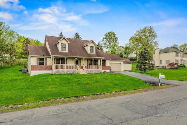 225 Northpark Dr W, East Stroudsburg, PA 18302 - new england style home with a porch, a garage, driveway, and a front yard