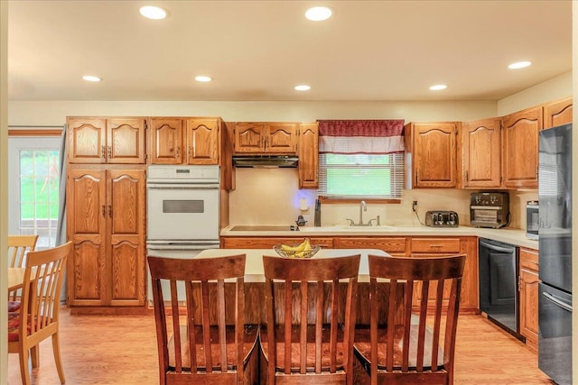 225 Northpark Dr W, East Stroudsburg, PA 18302 - kitchen featuring white oven, freestanding refrigerator, dishwasher, under cabinet range hood, and a sink