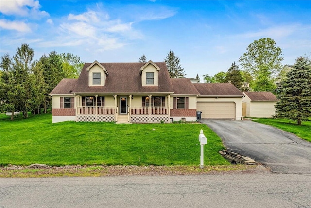 225 Northpark Dr W, East Stroudsburg, PA 18302 - cape cod-style house featuring a porch, a garage, driveway, and a front lawn