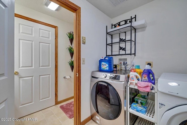 washroom featuring laundry area, independent washer and dryer, and baseboards