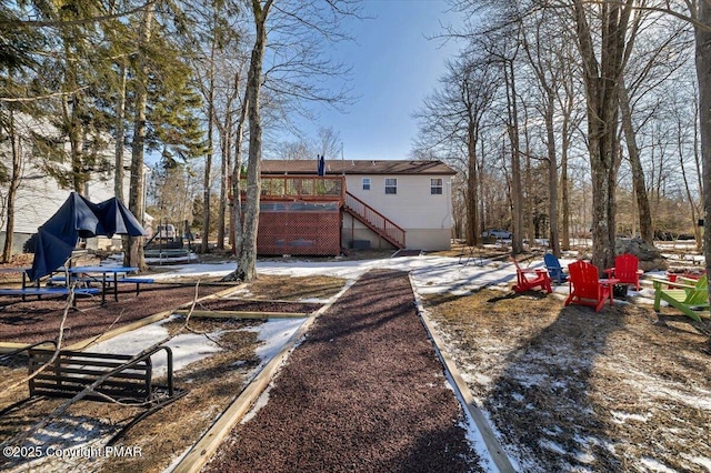 view of yard with a deck and stairs