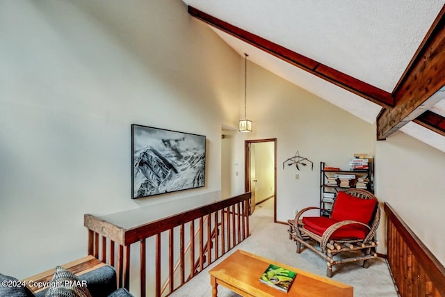 interior space with beam ceiling, an upstairs landing, carpet floors, and high vaulted ceiling