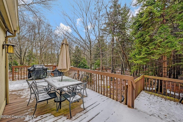 deck with outdoor dining area and a grill