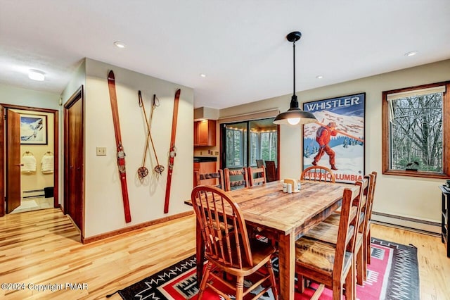 dining space featuring recessed lighting, a baseboard heating unit, baseboard heating, and light wood-style flooring