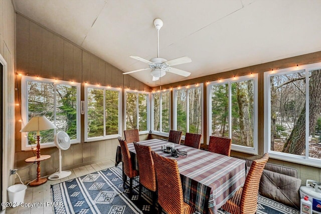 sunroom / solarium featuring lofted ceiling and ceiling fan