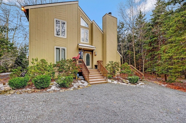 view of front of house featuring a chimney