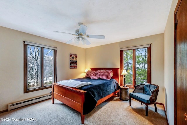 bedroom with baseboards, baseboard heating, a ceiling fan, and carpet