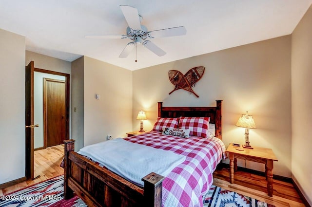 bedroom with baseboards, a ceiling fan, and wood finished floors