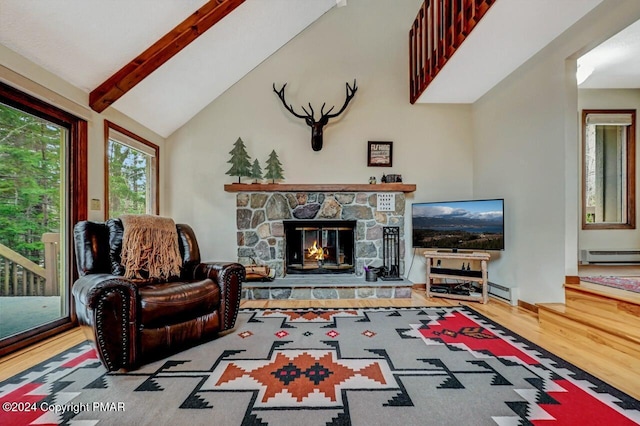 living area featuring wood finished floors, high vaulted ceiling, a stone fireplace, a baseboard heating unit, and beamed ceiling