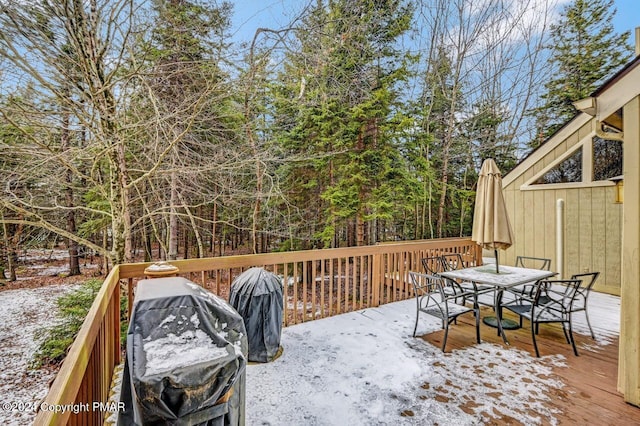 deck with area for grilling and outdoor dining space