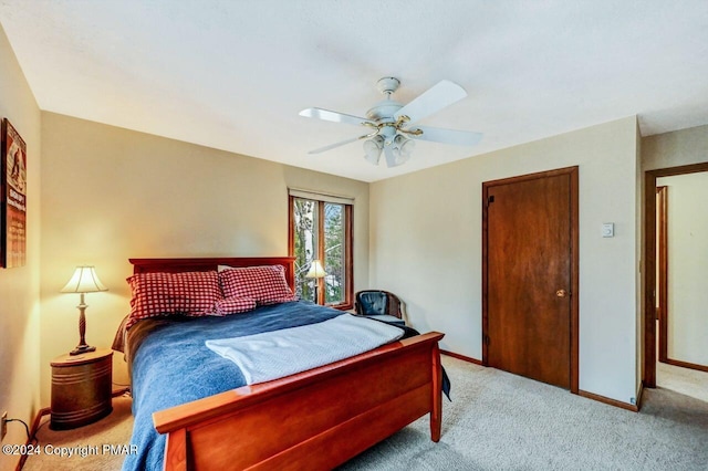 bedroom with ceiling fan, baseboards, and carpet floors