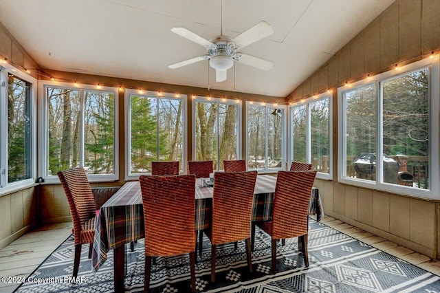 sunroom with ceiling fan and vaulted ceiling