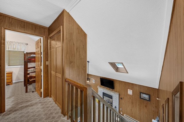 38 N Fairway Dr, Lake Ariel, PA 18436 - hall featuring wooden walls, an upstairs landing, a skylight, carpet, and a textured ceiling