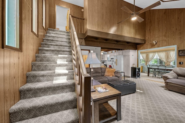 38 N Fairway Dr, Lake Ariel, PA 18436 - stairs featuring wooden walls, ceiling fan, a towering ceiling, and carpet