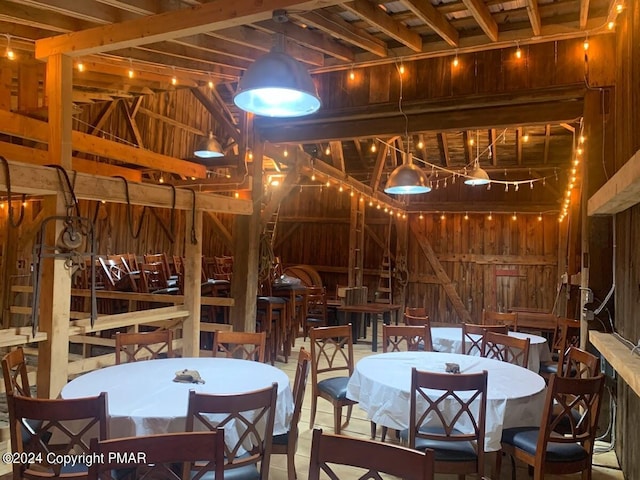 interior space with vaulted ceiling and wood walls