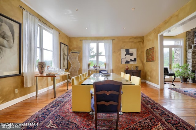 dining room with baseboards and hardwood / wood-style floors