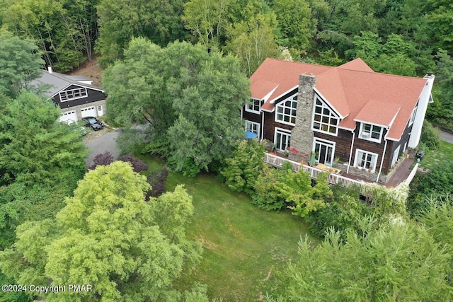 birds eye view of property with a forest view