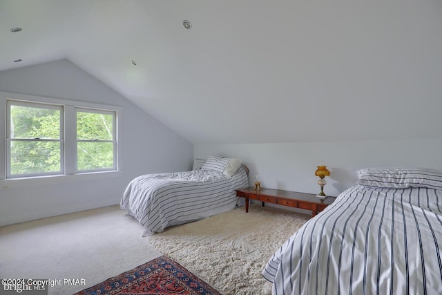 carpeted bedroom featuring lofted ceiling