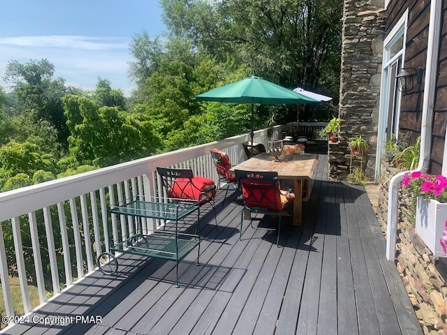 wooden terrace with outdoor dining area