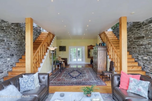 living room with french doors, stairway, and wood finished floors