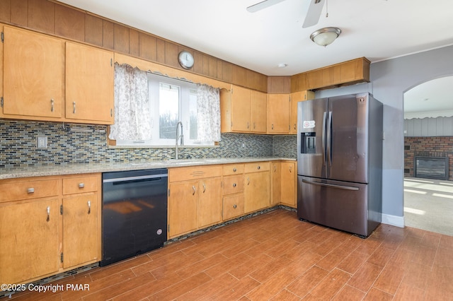 kitchen with stainless steel refrigerator with ice dispenser, light wood-type flooring, black dishwasher, ceiling fan, and backsplash