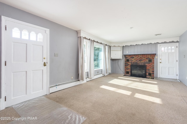 unfurnished living room featuring a baseboard heating unit, a fireplace, and light colored carpet