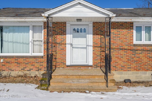 view of snow covered property entrance