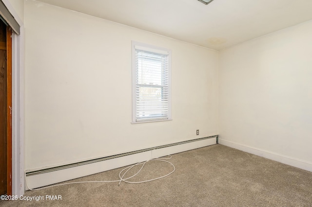 carpeted empty room with a baseboard radiator