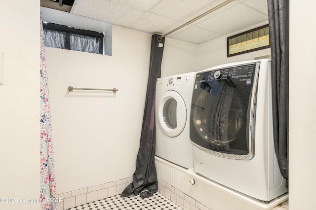 washroom with washing machine and clothes dryer