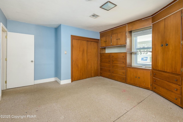 unfurnished bedroom with light carpet and a closet