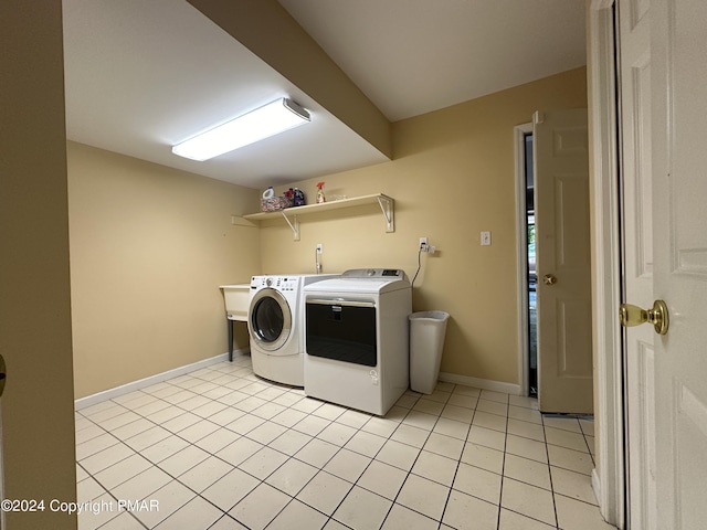 washroom featuring laundry area, light tile patterned floors, baseboards, and independent washer and dryer