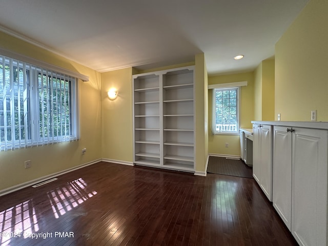 interior space featuring dark wood-type flooring, recessed lighting, visible vents, and baseboards