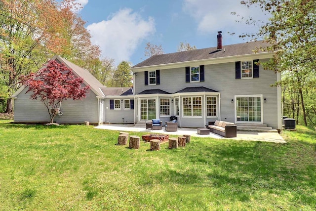 back of house with an outdoor hangout area, a patio area, a chimney, and a yard