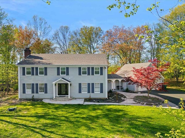 155 Kimberleigh Ct, East Stroudsburg, PA 18301 - view of front of home with a chimney, a front lawn, and asphalt driveway