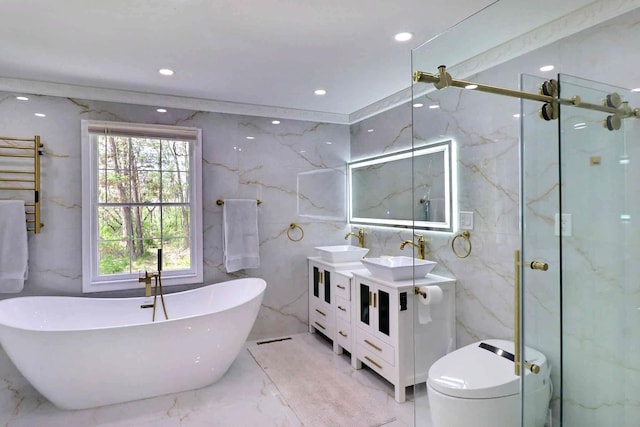 full bathroom with marble tiled floors, tile walls, a marble finish shower, a towel warmer, and a soaking tub