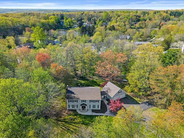 view of subject property with a forest