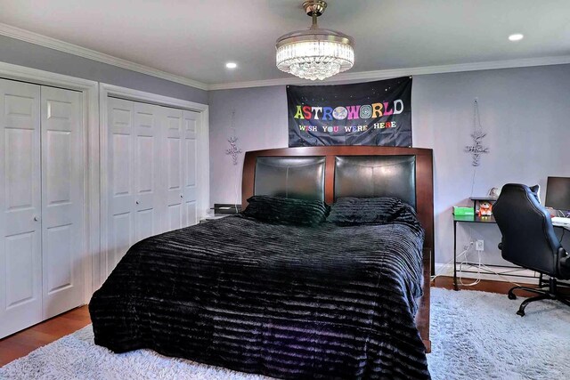 155 Kimberleigh Ct, East Stroudsburg, PA 18301 - bedroom featuring wood finished floors, two closets, crown molding, a chandelier, and recessed lighting