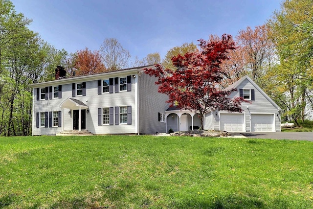 155 Kimberleigh Ct, East Stroudsburg, PA 18301 - colonial house featuring a chimney, driveway, a front lawn, and a garage