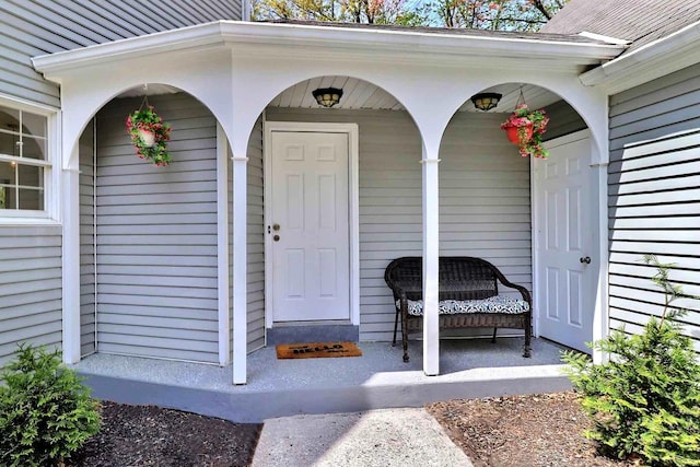 view of exterior entry with covered porch