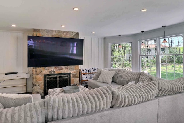living area featuring plenty of natural light, recessed lighting, and a fireplace