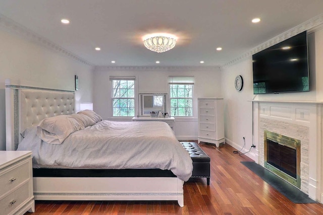 bedroom featuring dark wood-style floors, a premium fireplace, recessed lighting, and baseboards