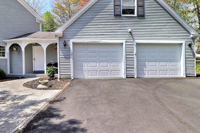 garage with asphalt driveway