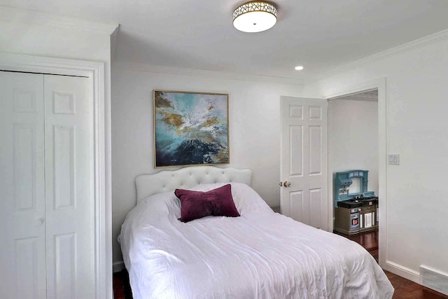 bedroom with ornamental molding, dark wood-style floors, and baseboards