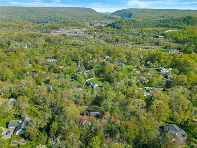 aerial view of property and surrounding area with a heavily wooded area
