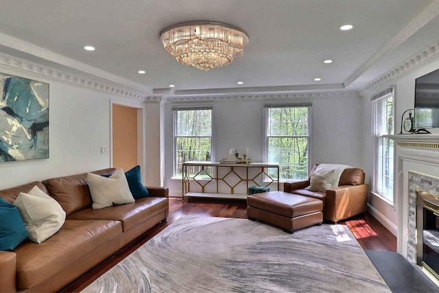 living area featuring a high end fireplace, wood finished floors, plenty of natural light, and recessed lighting