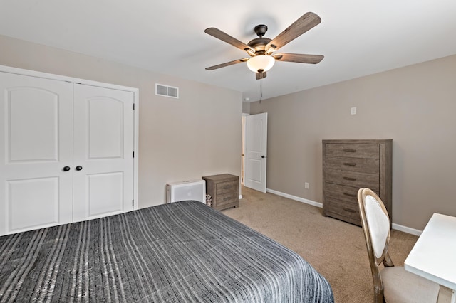 unfurnished bedroom with carpet floors, a closet, visible vents, ceiling fan, and baseboards