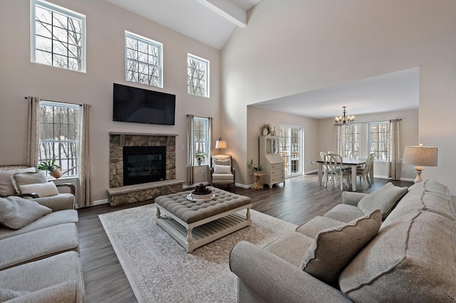 living room with a stone fireplace, dark wood-type flooring, beam ceiling, and baseboards