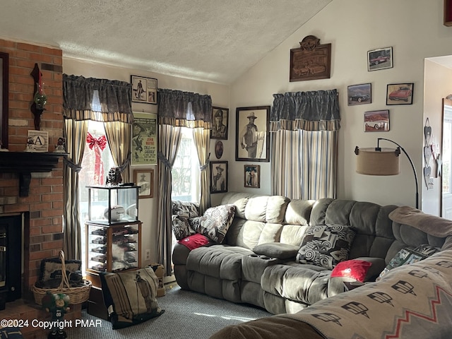 living room with a textured ceiling, vaulted ceiling, and a fireplace